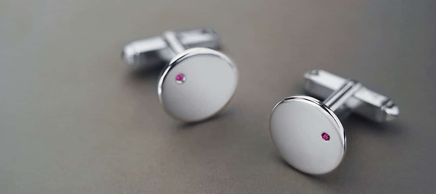 Silver cufflinks with small, round ruby