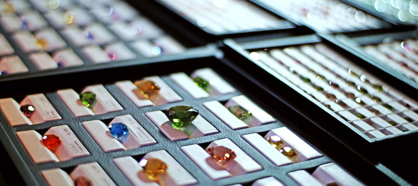 Multicoloured precious gemstones in display cases