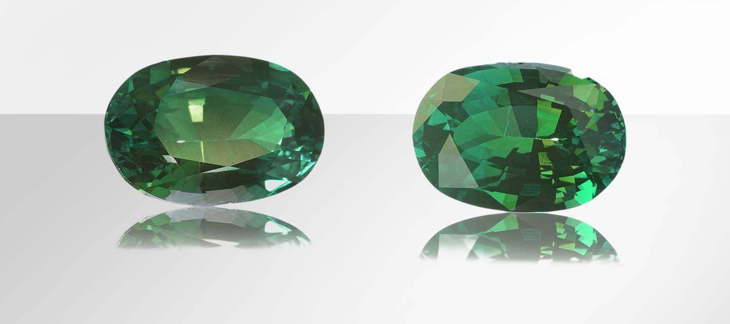 Oval cut emerald gemstones on white background