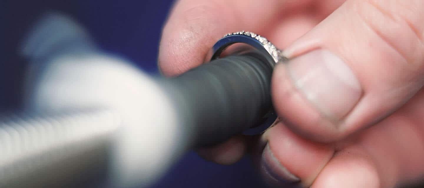 Silver ring being polished by hand