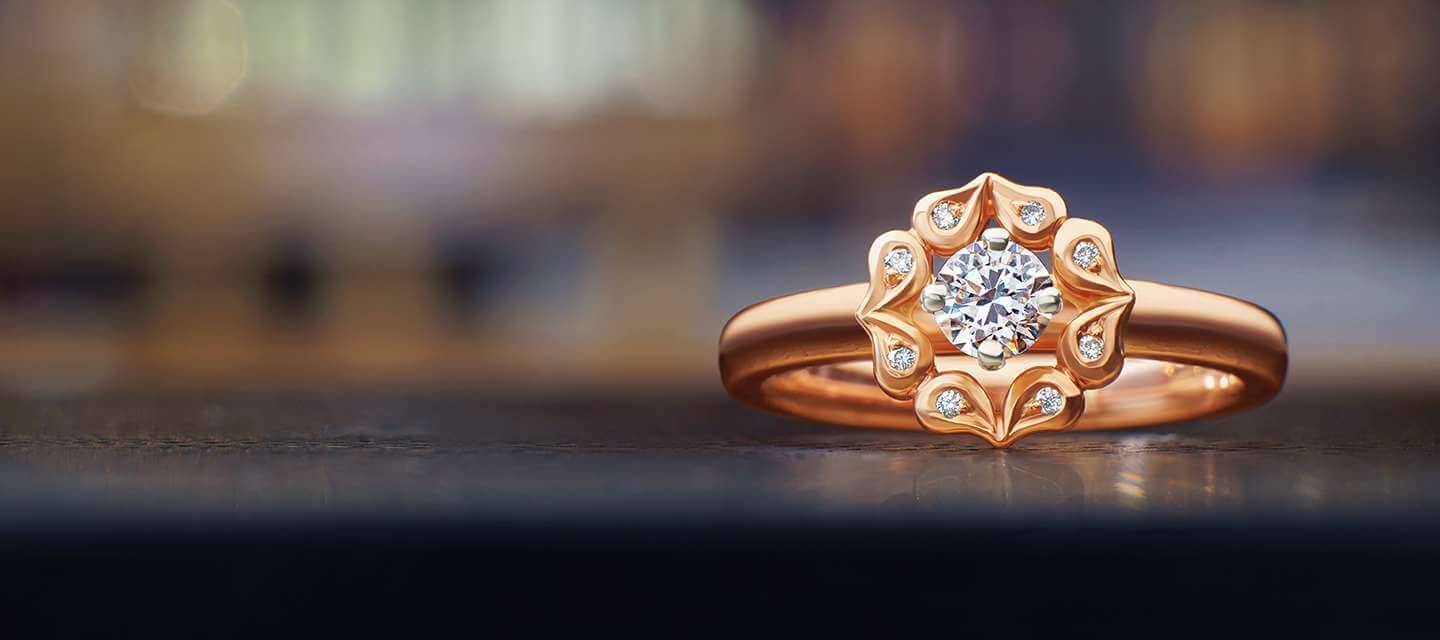 Rose shaped wedding ring on black table