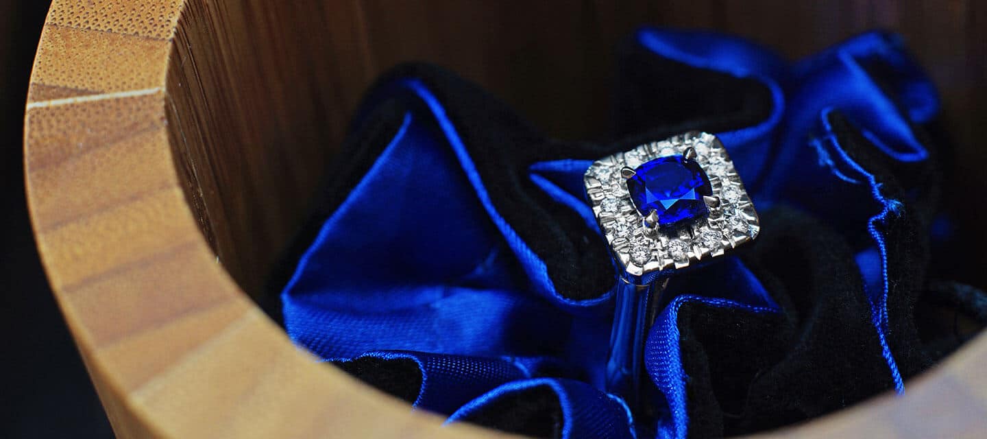 Sapphire engagement ring on blue silk background