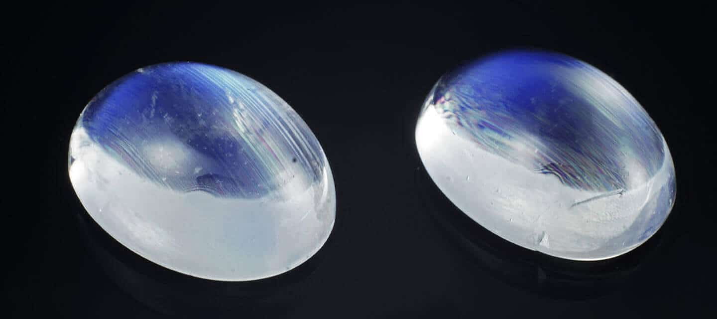 two oval moonstones on black background