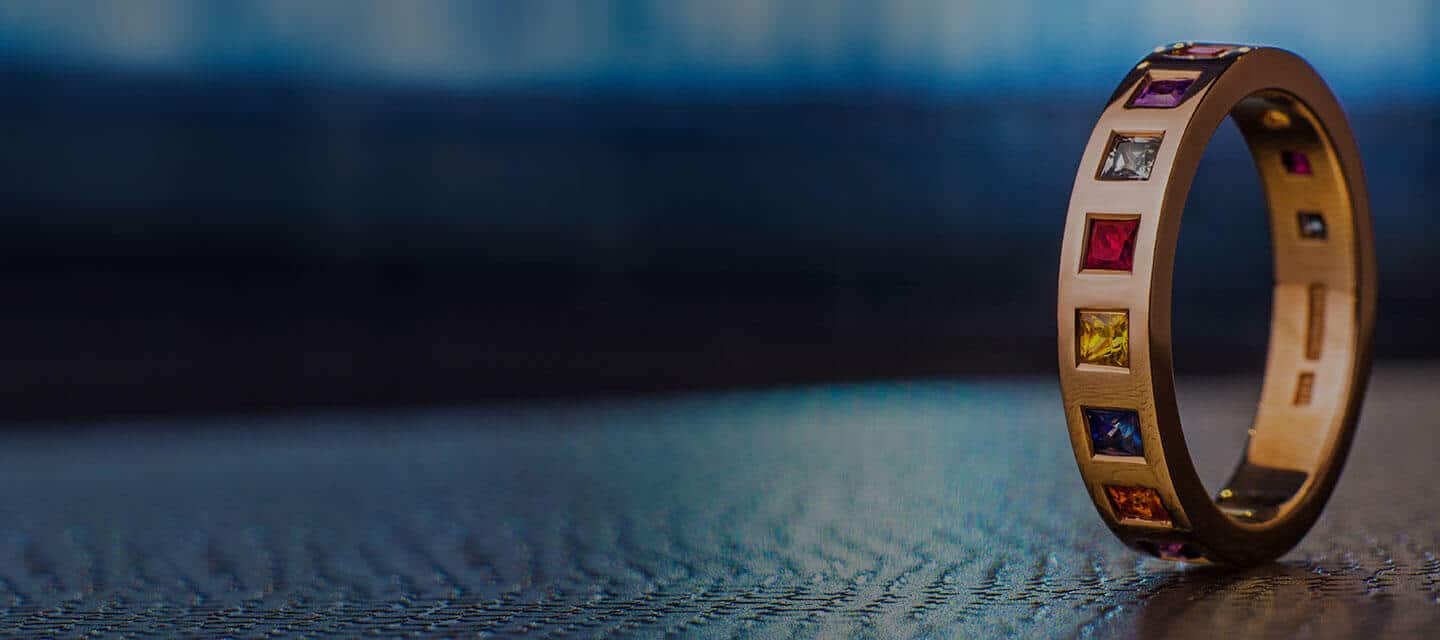 multicoloured eternity ring on table