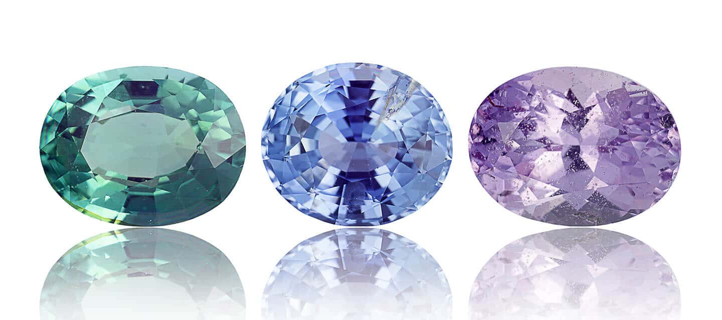 Green blue and purple gemstone in a row