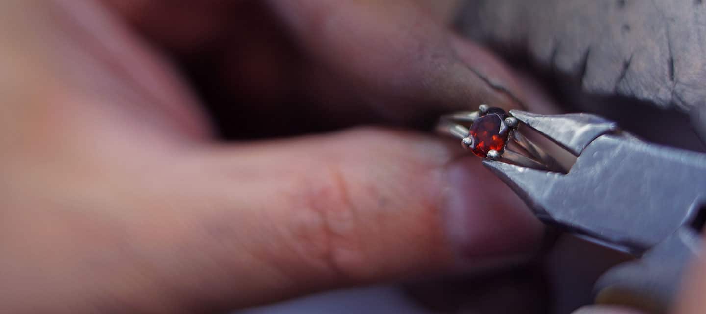 Garnet ring held between fingers