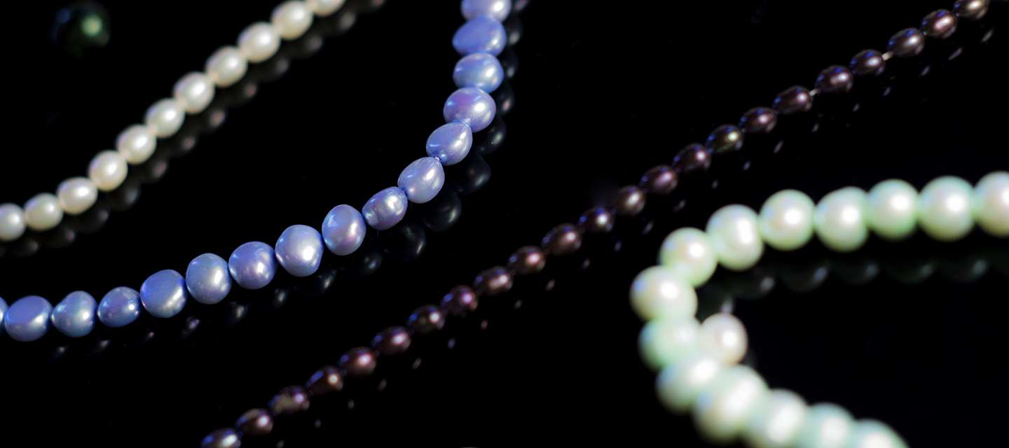 Pearls jewellery on black background