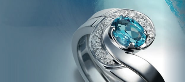 Twist engagement ring with blue stone and diamonds