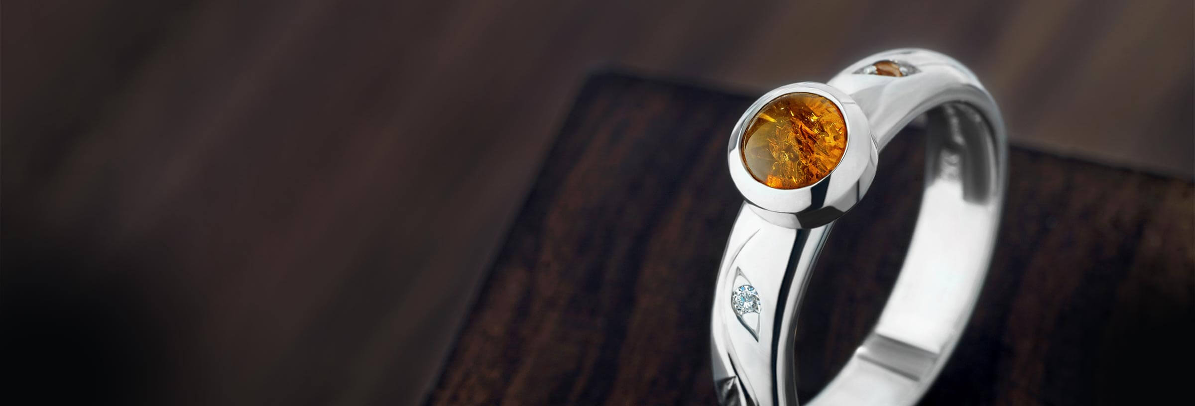 White metal engagement ring with amber