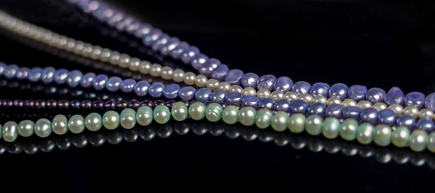 multicoloured strung pearl in a row