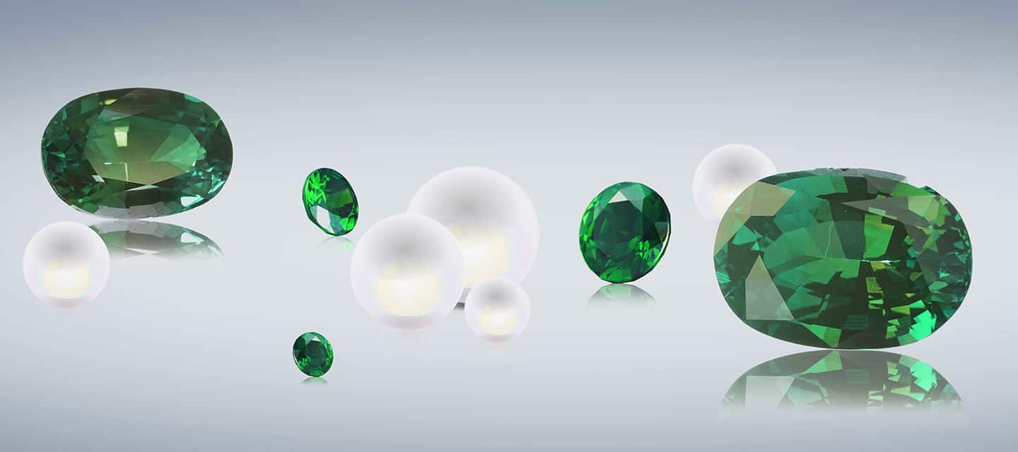 Mixed size emerald and pearls on surface