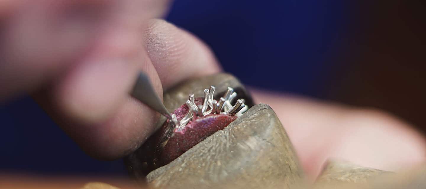 Closeup of goldsmith hand repairing ring