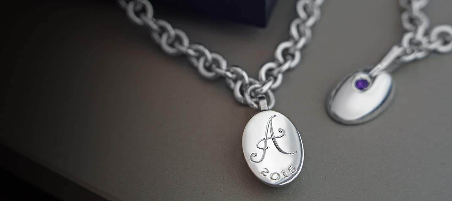 Engraved initial charm on a link chain