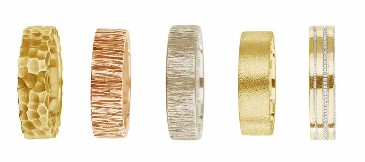 a line of 5 gold rings with mixed textures