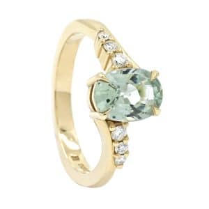 oval green gemstone ring with diamond shoulders