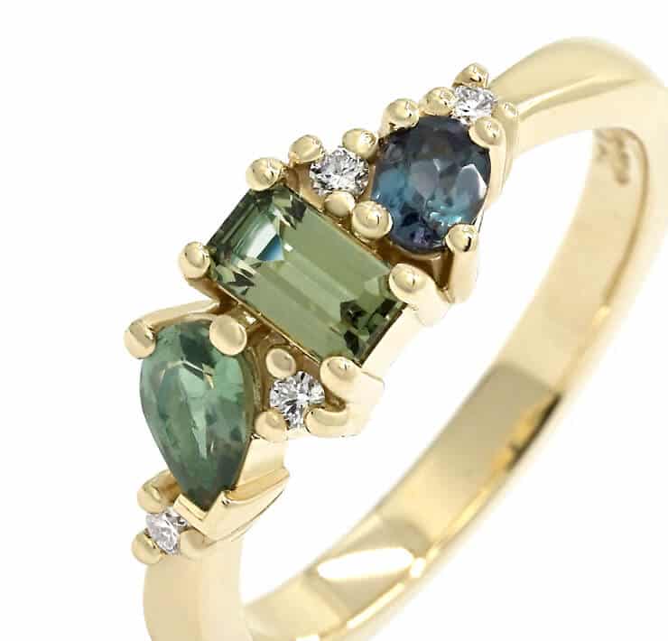 alexandrite and mixed cut green blue gemstone ring close up