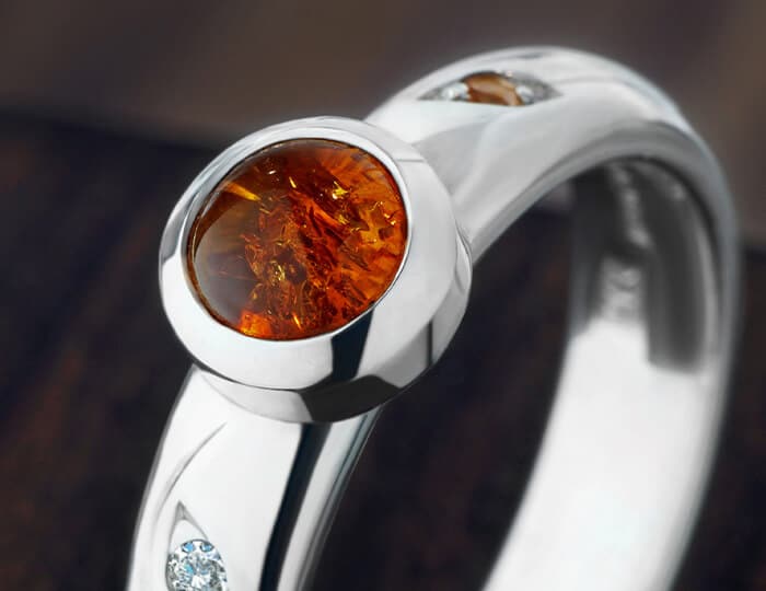 Amber set ring with shoulder stones