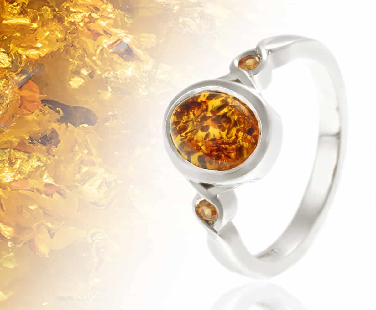 oval amber ring with gemstone detail behind