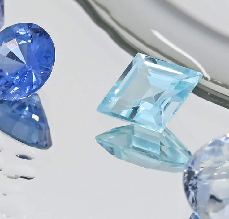 blue gemstones with water droplets close up