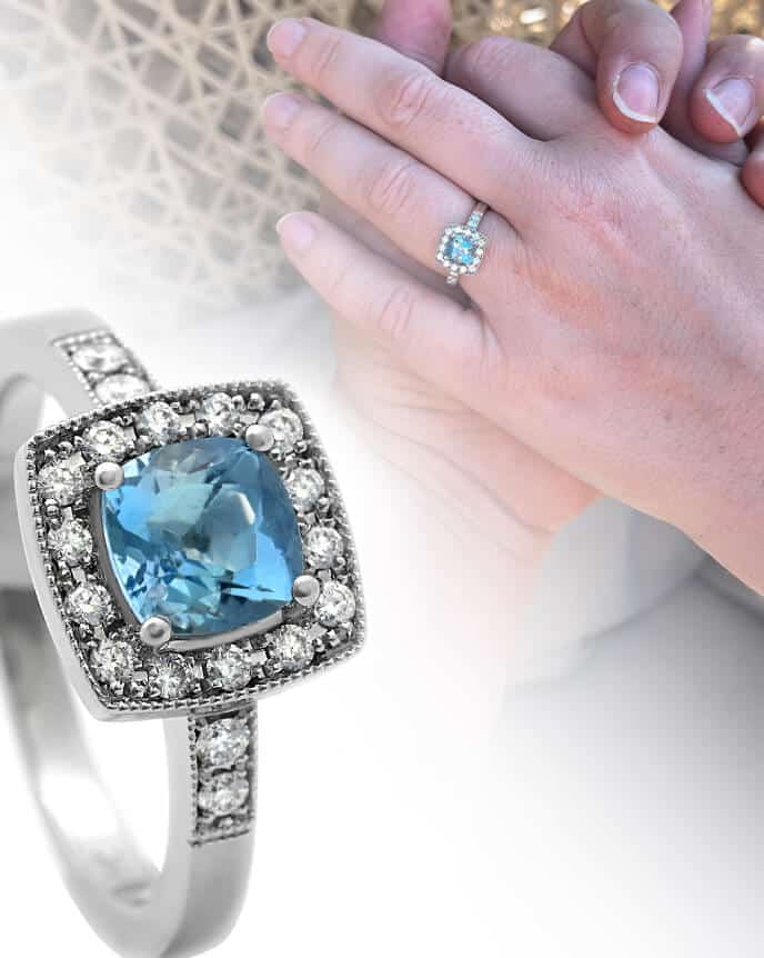 asscher cut blue halo engagement ring and fingers