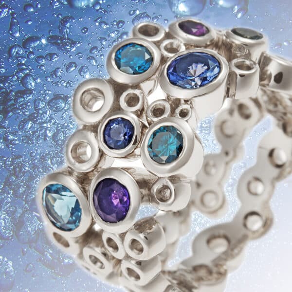 bubble inspired wide scatter set sapphire ring with bubbles behind