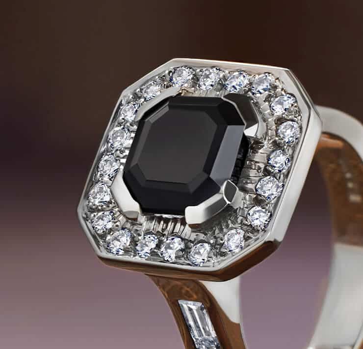 statement onyx ring with halo of diamonds around close up