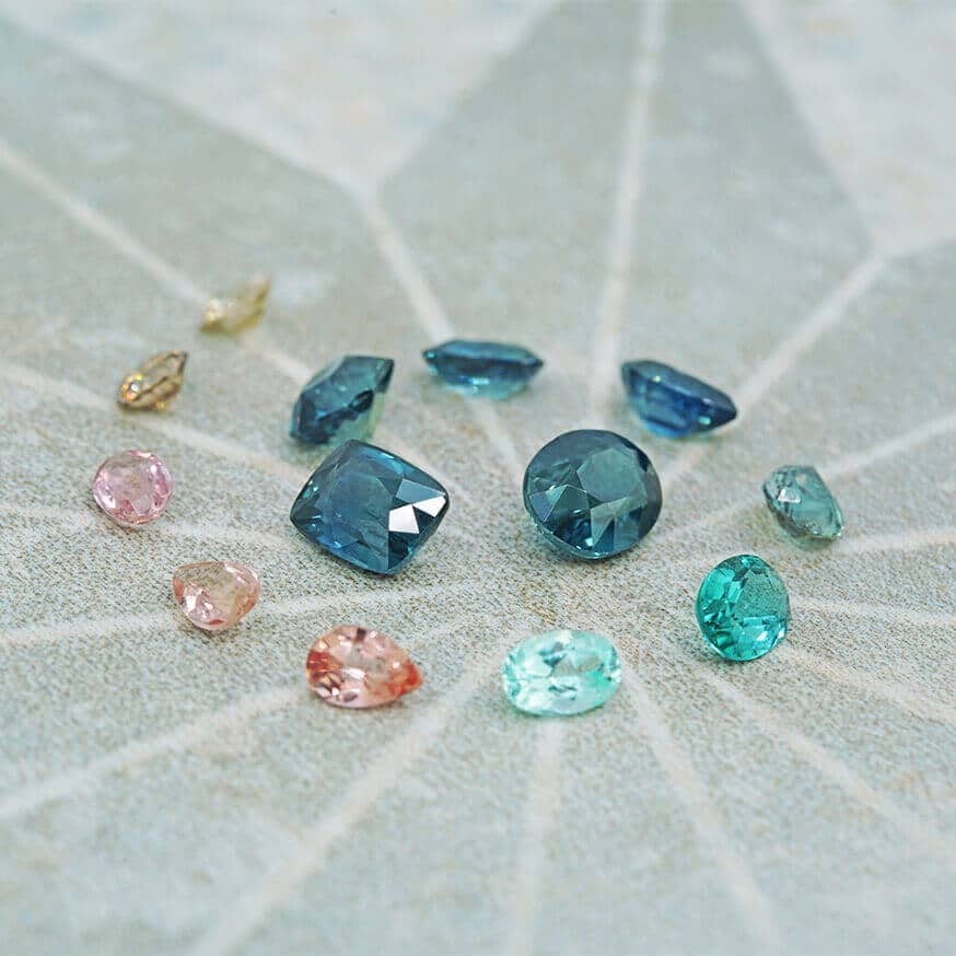 Spiral of gemstones from teal to pink