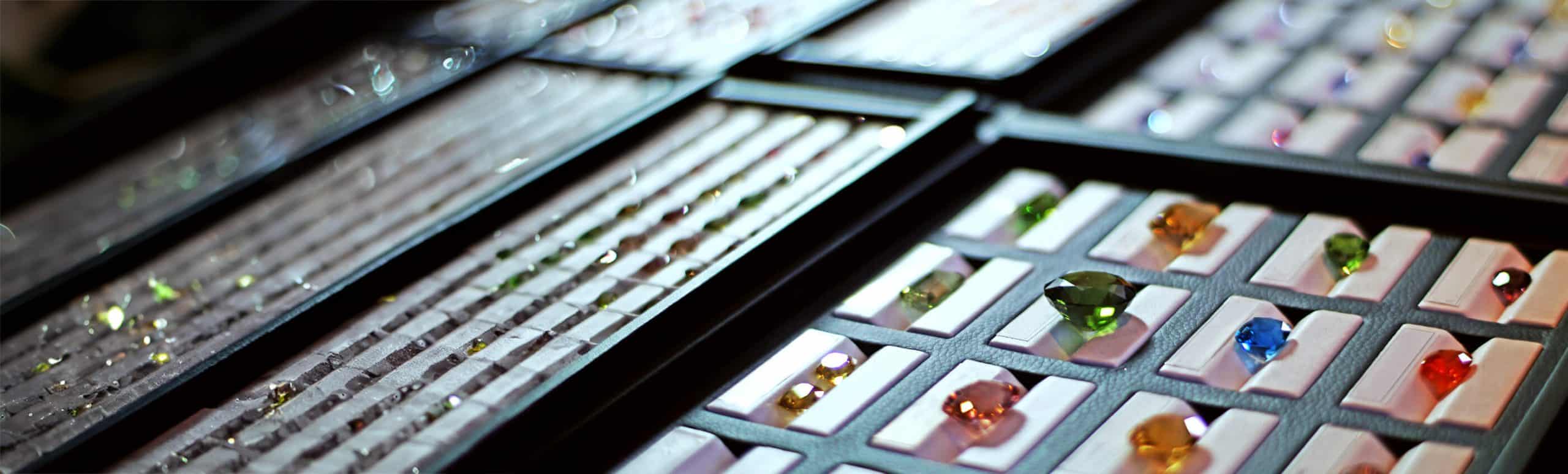 Coloured gemstones in white display trays