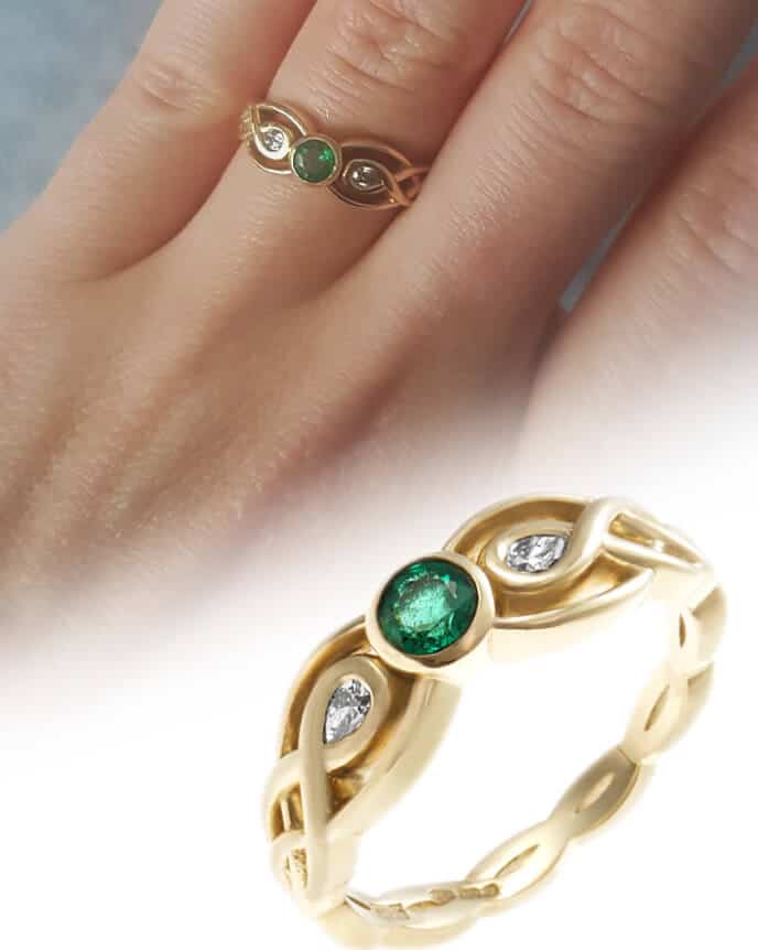 Celtic style emerald ring on finger