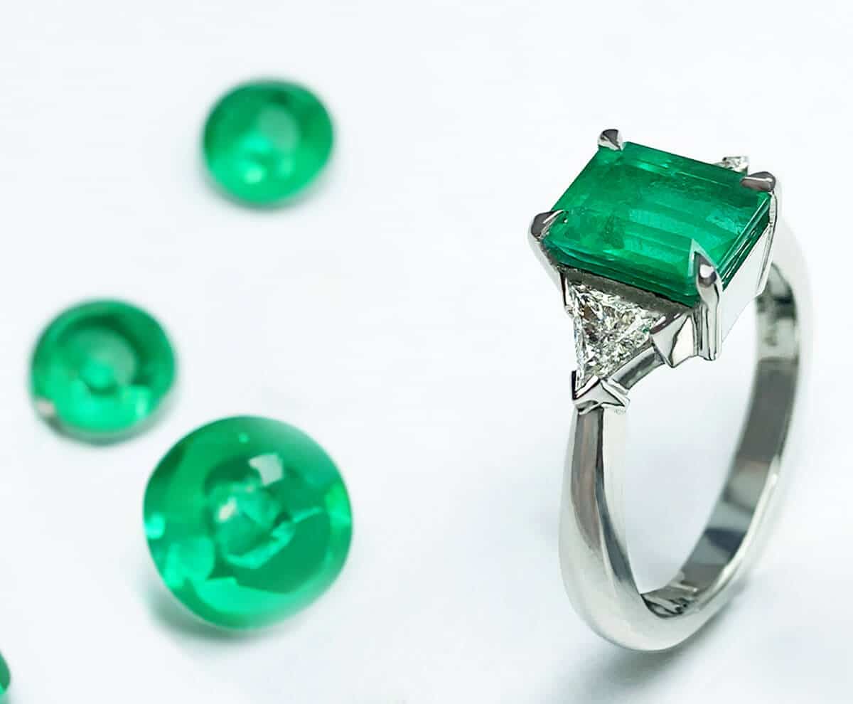 Green art deco style emerald ring with loose green gemstones