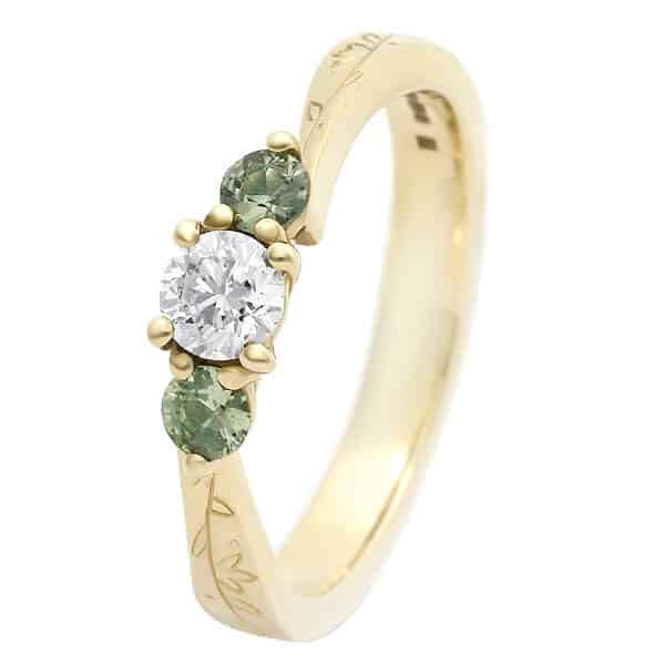 diamond trilogy with green sapphire gold engraved ring