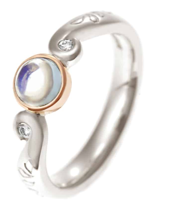 swirling designed ring with moonstones and diamonds