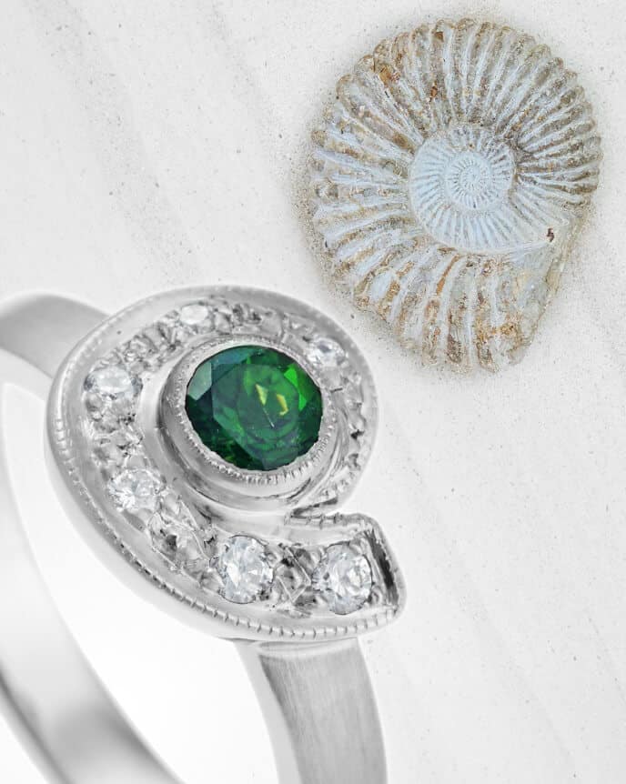 green gemstone ammonite shaped ring with fossil