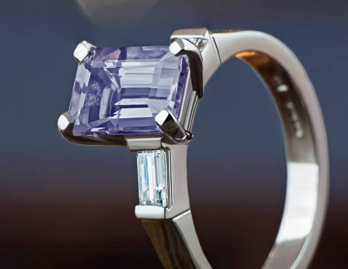 Iolite and diamond trilogy engagement ring