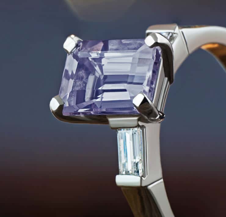 emerald cut facetted iolite with baguette cut diamonds close up