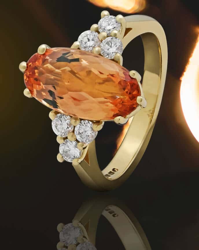 long oval orange topaz ring with side diamonds