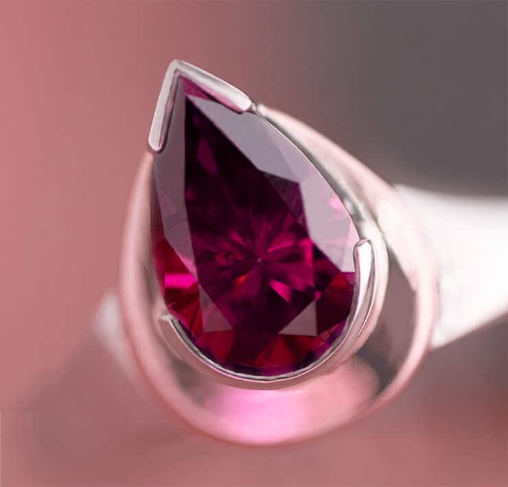 Red pink pear shaped large ruby in ring close up