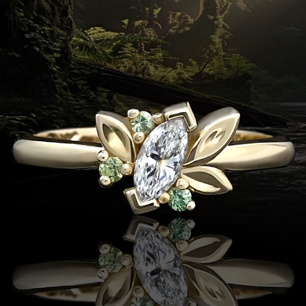 leaf shaped diamond and green gemstone ring over forest