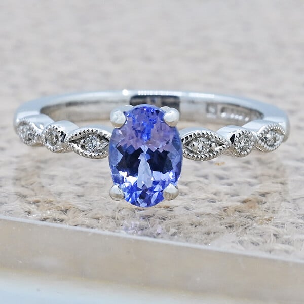 oval cut tanzanite with engraved banded ring