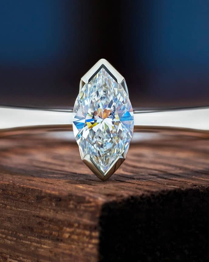 Marquise cut platinum solitaire on wood