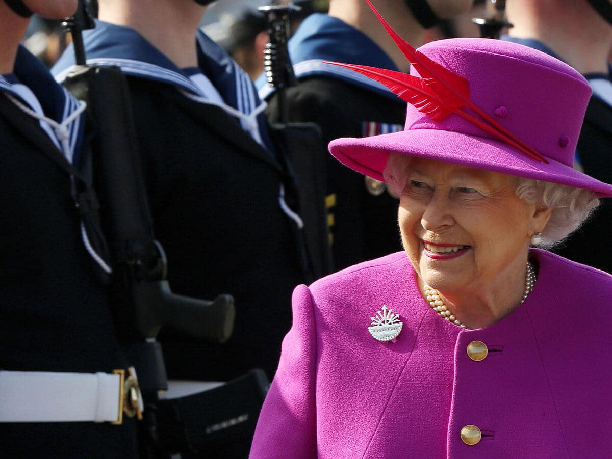 Queen wearing navy brooch