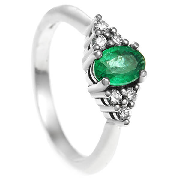 oval green emerald with 6 side diamond ring