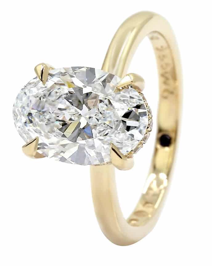 large oval diamond solitaire and gold band