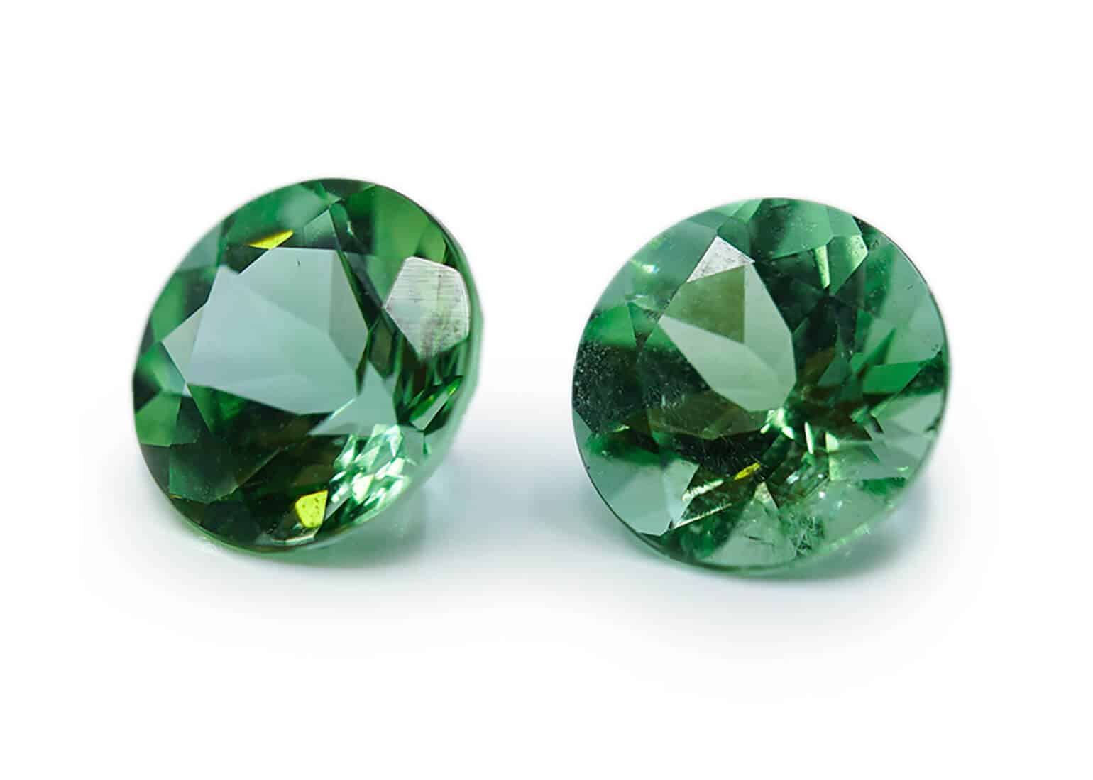 Pair of small round green emeralds