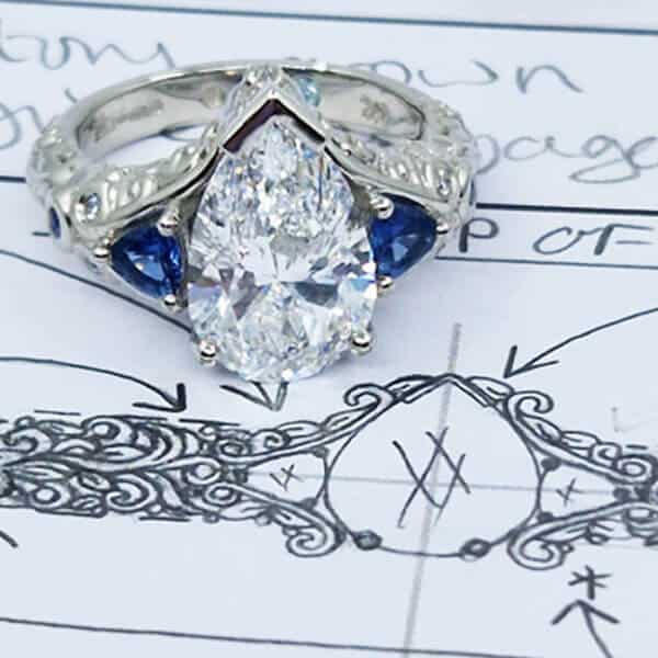 large pear diamond with sapphires over sketch