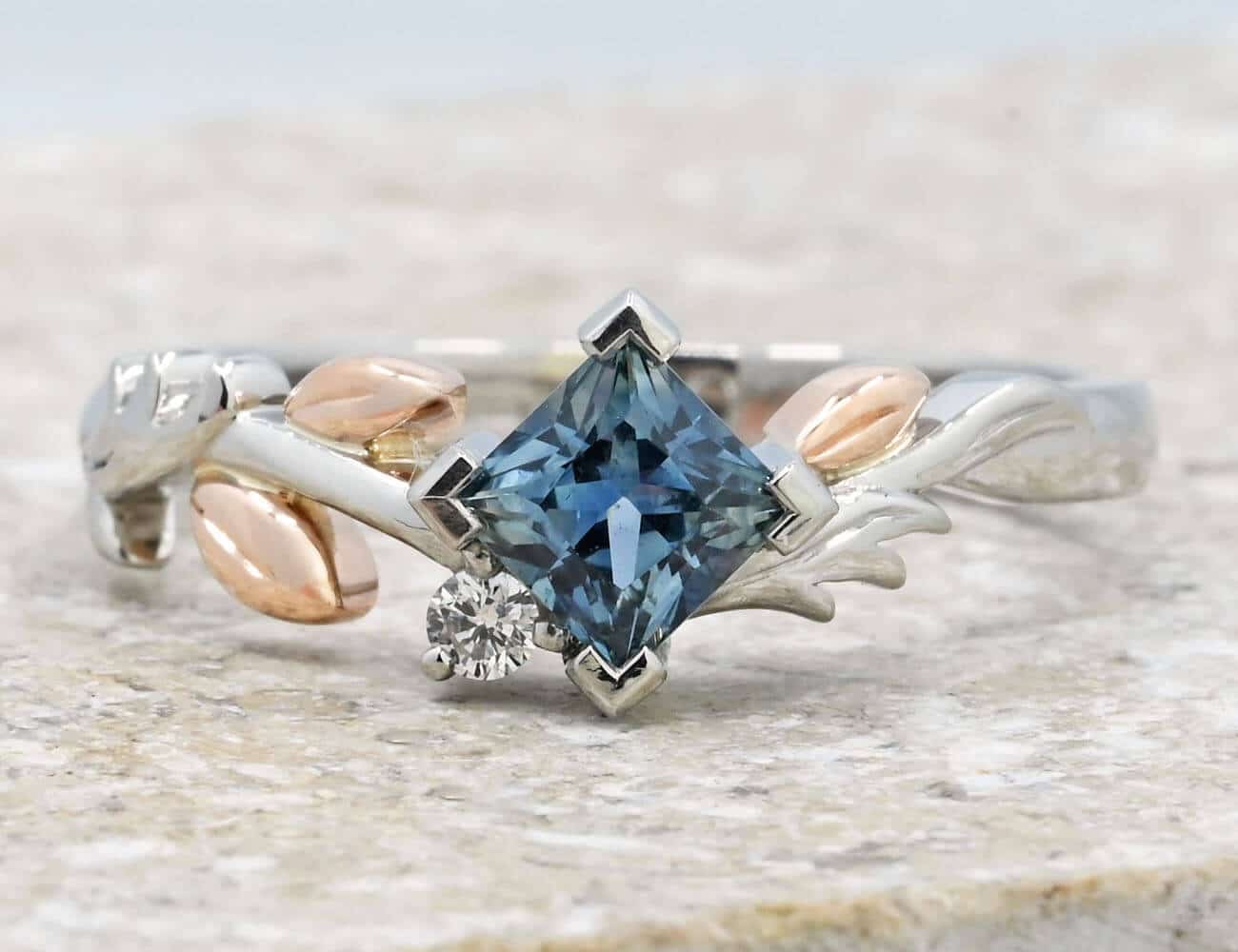 offset set sapphire with mixed metal leaf designed ring