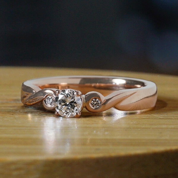 diamond twist style engagement ring in rose gold