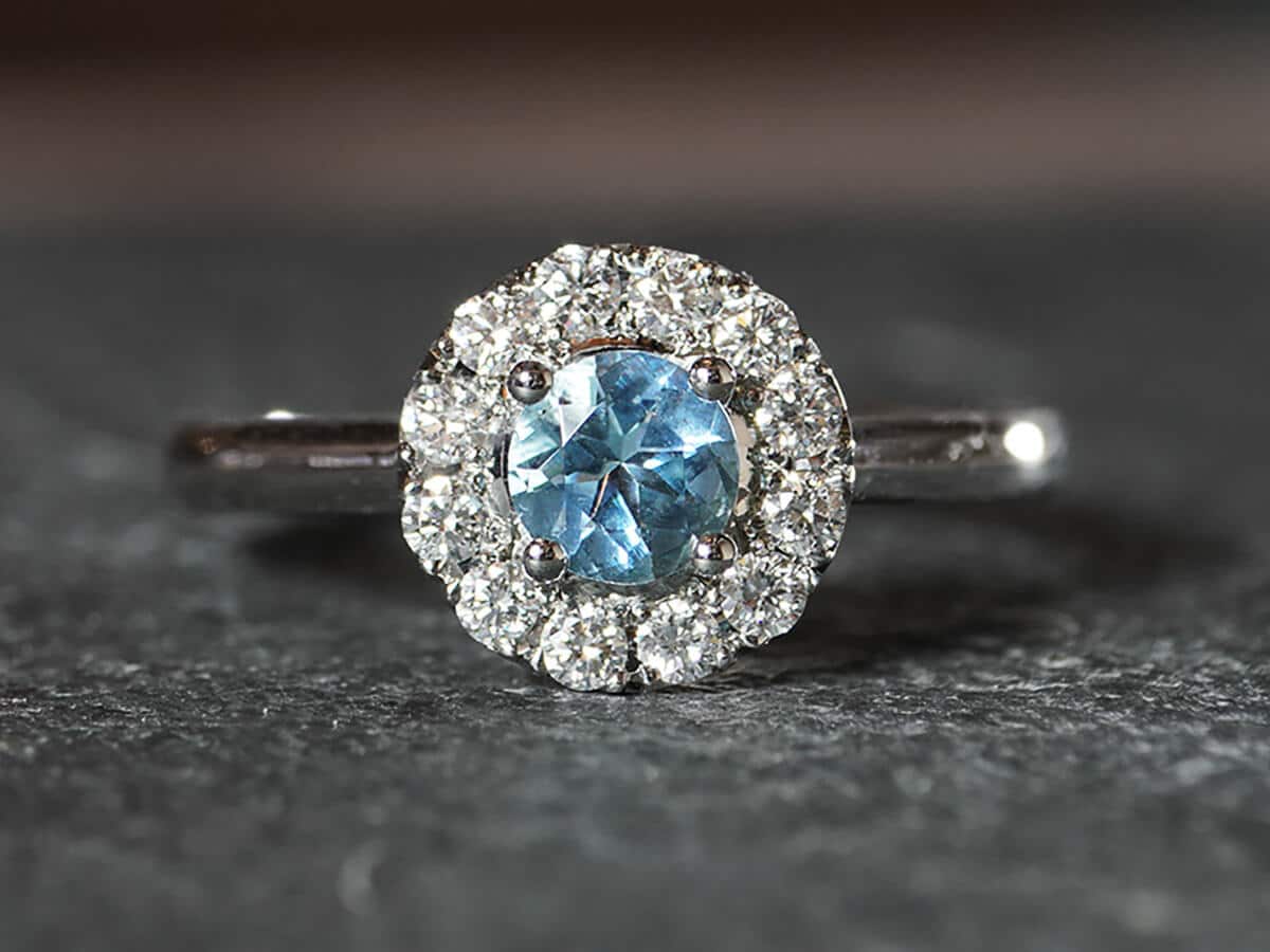 Round aquamarine and diamond halo engagement ring