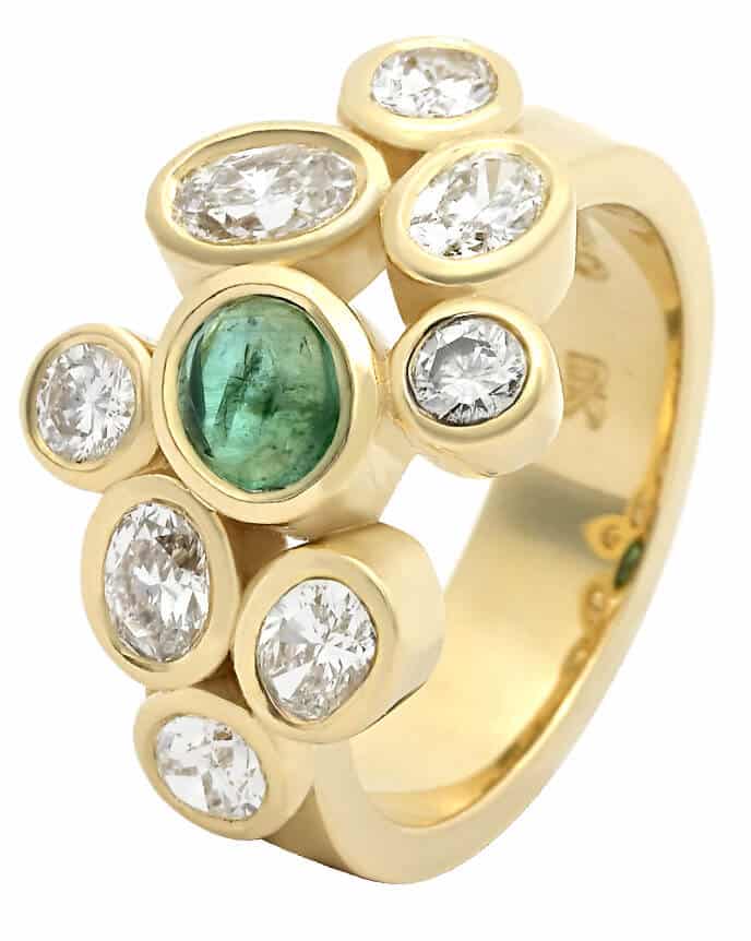 scatter set diamond and single emerald ring