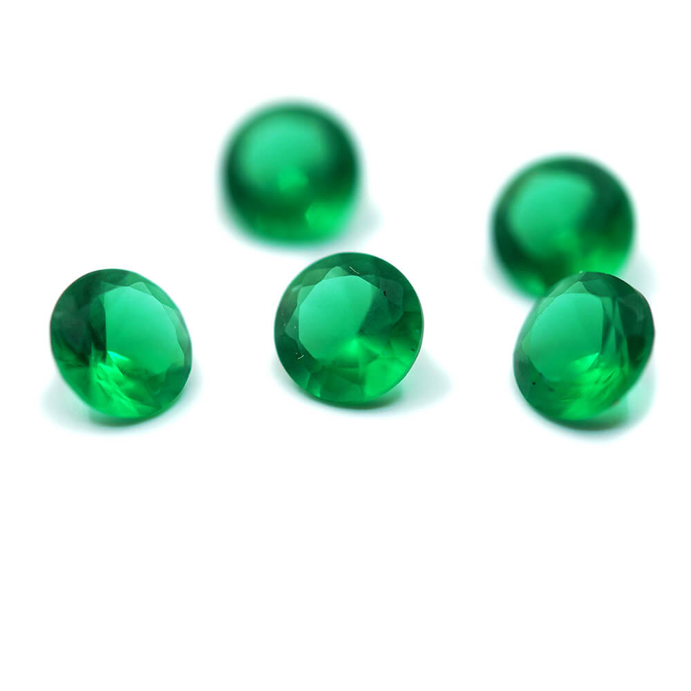 group of 5 small round emeralds on white